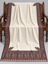Ivory Kani Moonlight shawl with multicolour paisley border displayed open on a studio bench — Taj Mehal Handicrafts