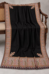 Black Kani Moonlight shawl with subtle zari paisley border displayed open on a studio bench — Taj Mehal Handicrafts