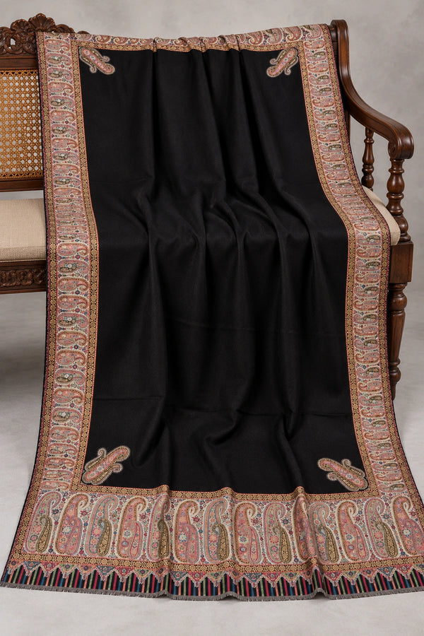 Black Kani Moonlight shawl with subtle zari paisley border displayed open on a studio bench — Taj Mehal Handicrafts