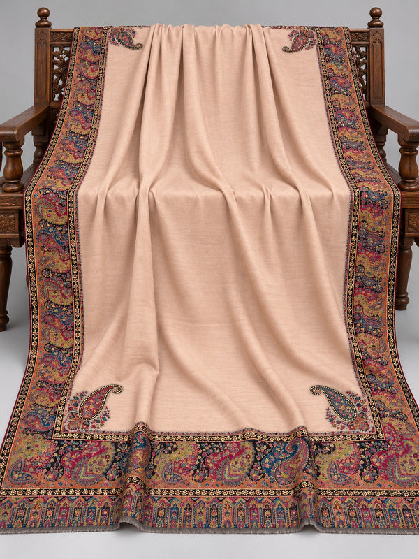 Blush beige Kani shawl with multicolour paisley border displayed open on a studio bench — Taj Mehal Handicrafts