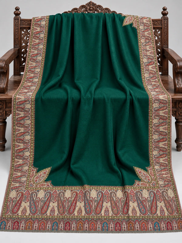 Emerald green Kani shawl with multicolour paisley border displayed open on a studio bench — Taj Mehal Handicrafts