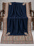 Navy blue Kani shawl with a multicolour paisley border displayed open on a studio bench — Taj Mehal Handicrafts