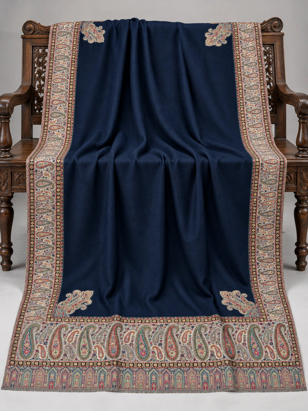 Navy blue Kani shawl with a multicolour paisley border displayed open on a studio bench — Taj Mehal Handicrafts