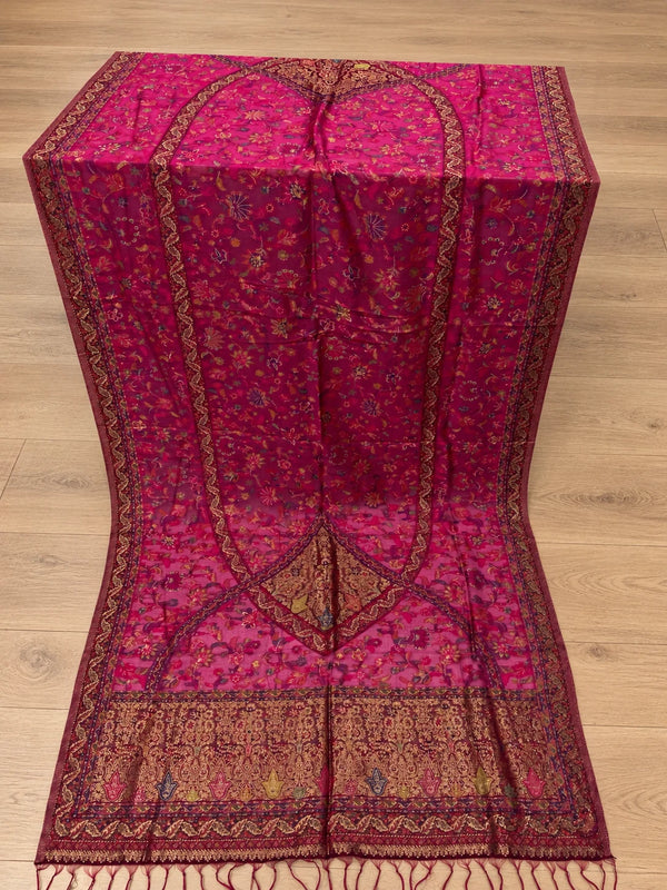 Pink unstitched suit dupatta with small floral motifs and ornate paisley borders, displayed on a wooden floor – Taj Mehal Handicrafts