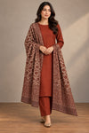 Model wearing a rust unstitched two-piece suit with Moonlight floral paisley shawl